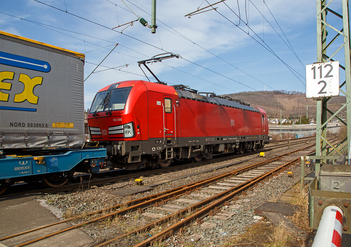 Die 193 358 (91 80 6193 358-9 D-DB) der DB Cargo Deutschland AG, zieht am 16.03.2021 einem KLV-Zug durch Niederschelden in Richtung Siegen. Zuvor hatte sie im Bahnhof Niederschelden länger Hp 0.

Die Siemens Vectron MS wurde 2018 von Siemens Mobilitiy in München-Allach unter der Fabriknummer 22481 gebaut. Die Vectron MS hat eine Leistung von 6,4 MW und ist für 200 km/h in Deutschland, Österreich, Schweiz, Italien und die Niederlande zugelassen.  
