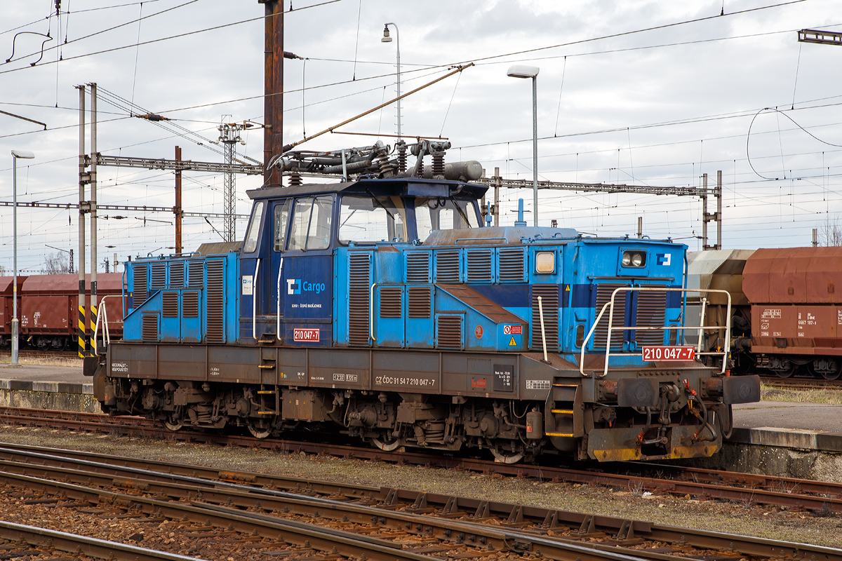Die ČD Cargo 210 047-7 (CZ ČDC 91 54 7 210 047-7) steht am 28.03.2016 im Bahnhof Cheb.

Die E-Lok wurde 1979 von �koda in Plzeň (Pilsen) unter der Fabriknummer 7265 gebaut.

Die ČD Baureihe 210, ex ČSD-Baureihe S 458.0 (ab 1988 Baureihe 210) ist eine elektrische Rangierlokomotive f�r 25 kV 50 Hz Wechselstrom.  Sie wurde gleichzeitig mit der Gleichstromlok E 458.0 (heute BR 110) entwickelt, um auf gr��eren Personen- sowie G�terbahnh�fen den Verschub sowie die Bef�rderung von �bergabefahrten durchzuf�hren. Der mechanische Teil ist identisch mit dem der E 458.0, nur im elektrischen Aufbau hat die Lokomotive einen Trafo und eine andere Steuerung. Eine minimale Geschwindigkeit bis zu 5 km/h ist m�glich. Die Lokomotiven sind mit einem speziellen Trafo f�r die Beheizung des Zuges mit 1,5 kV bzw. 3 kV 50 Hz ausger�stet, und k�nnen somit auch im Personenzugdienst eingesetzt werden. Das �bersetzungsverh�ltnis zwischen Fahrmotorritzel und Gro�rad betr�gt 1:4,055, was der Lokomotive eine H�chstgeschwindigkeit von 80 km/h erm�glicht. F�r den Betrieb auf nicht elektrifizierten Streckenteilen besitzt die Lok Akkumulatoren.

Technische Daten:
Gebaute St�ck: 74
Spurweite: 1.435 mm (Normalspur)
Achsformel: Bo’Bo’
L�nge �ber Puffer: 14.400 mm
Rahmenl�nge:  13.160 mm
Breite: 3.000 mm
H�he (Pantograph gesenkt):  4.625 mm
Achsstand im Drehgestell : 2.800 mm
Der Gesamt Radstand von 9.600 mm
Drehzapfenabstand:  6. 300 mm
Treibradraddurchmesser: 1.050 mm (neu) / 980 mm (abgenutzt)
Kleister befahrb. Kurvenradius: R = 120 m
Dienstgewicht: 72 t
Max. Achslast : 18 t
Stundenleistung: 984 kW
Dauerleistung: 880 kW
Anfahrzugkraft:  max. 164 kN
Fahrmotoren: 4 St�ck Typ TE 006 
Stromsystem: 25 kV 50 Hz AC (Wechselstrom)