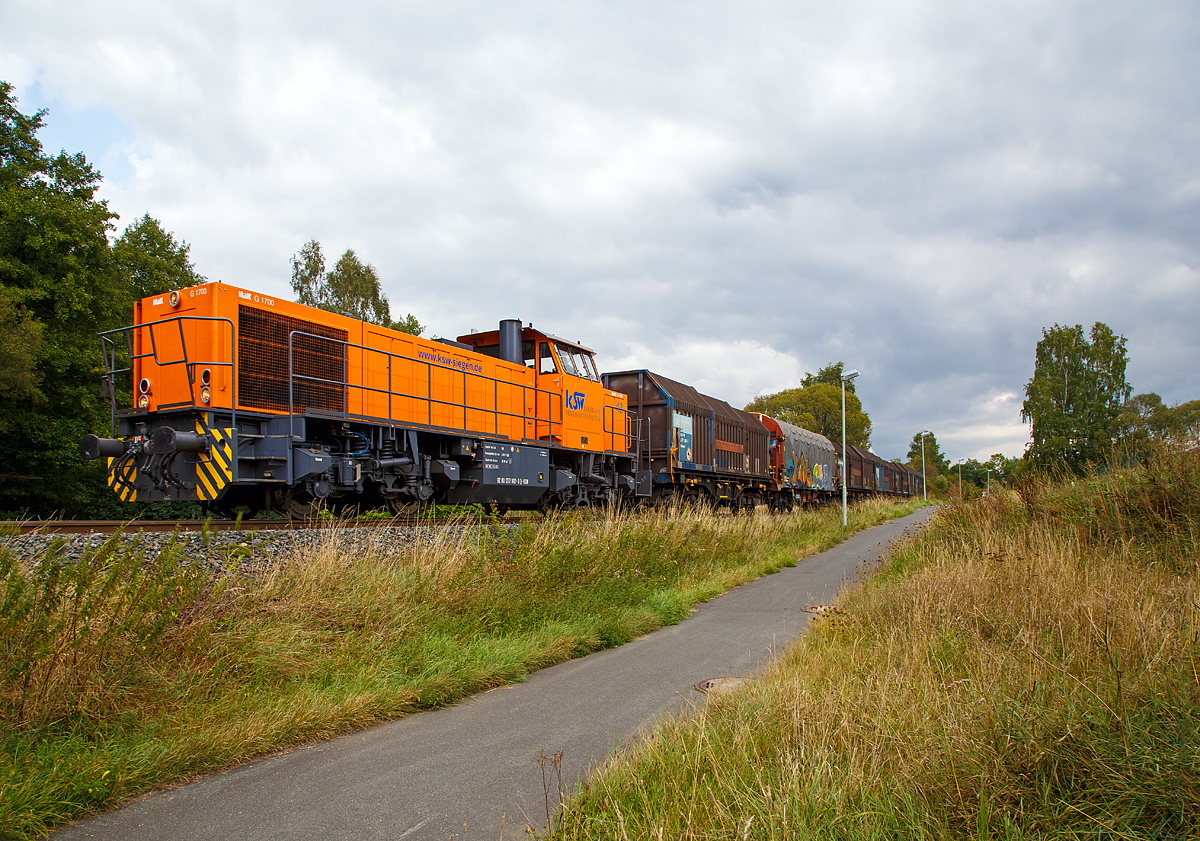 
Die Lok 42 (92 80 1277 902-3 D-KSW) der Kreisbahn Siegen-Wittgenstein (KSW), eine Vossloh MaK G 1700 BB, fährt am 30.08.2018 mit leeren Coil-Wagen durch Neunkirchen-Struthütten in Richtung Herdorf.